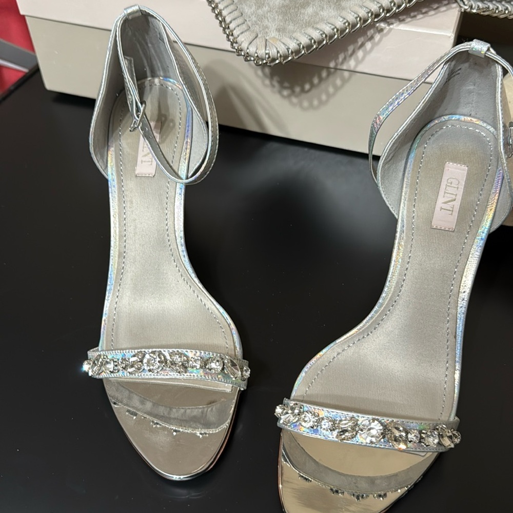Silver metallic with strap with 3inch heel.